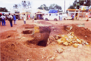 This photo scene shows the center of war ravaged Zorzor, once a bustling city. It is one of the many scenes captured by Journalist James Fasuekoi in 1998 in the aftermath of the mass excavation of the remains of hundreds of young men mainly from the Lorma tribe reportedly buried alive by Alhaji Kromahxs rebels during the Liberian civil war. The exercise covered Yeala, Zorzor, Fessibu and Bokeza with the recovery of the skeletal remains of several victims.  Photo © by James Fasuekoi.